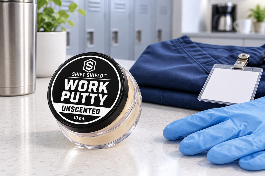 Unscented Work Putty 10 mL Mini beside folded navy scrubs, a blank badge and clean blue gloves in a healthcare staff area.